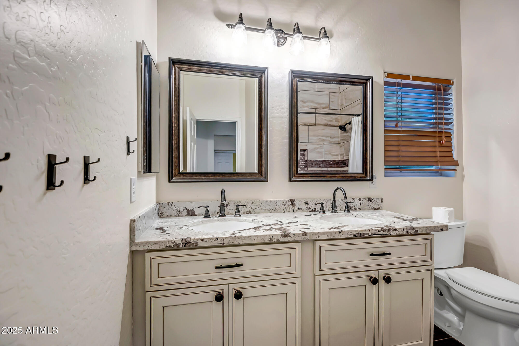 9569 West Redbird Road Peoria, AZ 85383 - Photo 23 of 36 a bathroom with a double vanity sink and a mirror