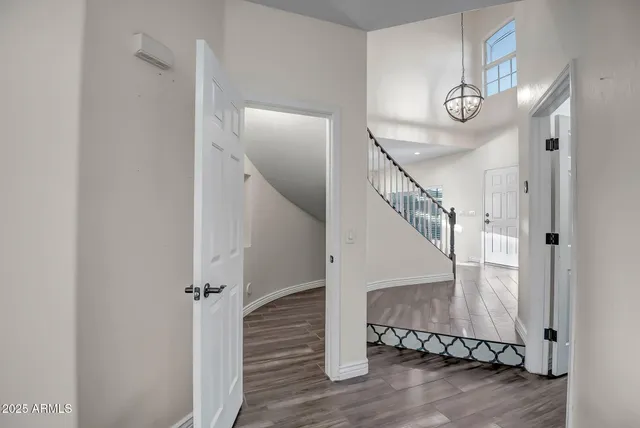 a view of entryway and hall with wooden floor