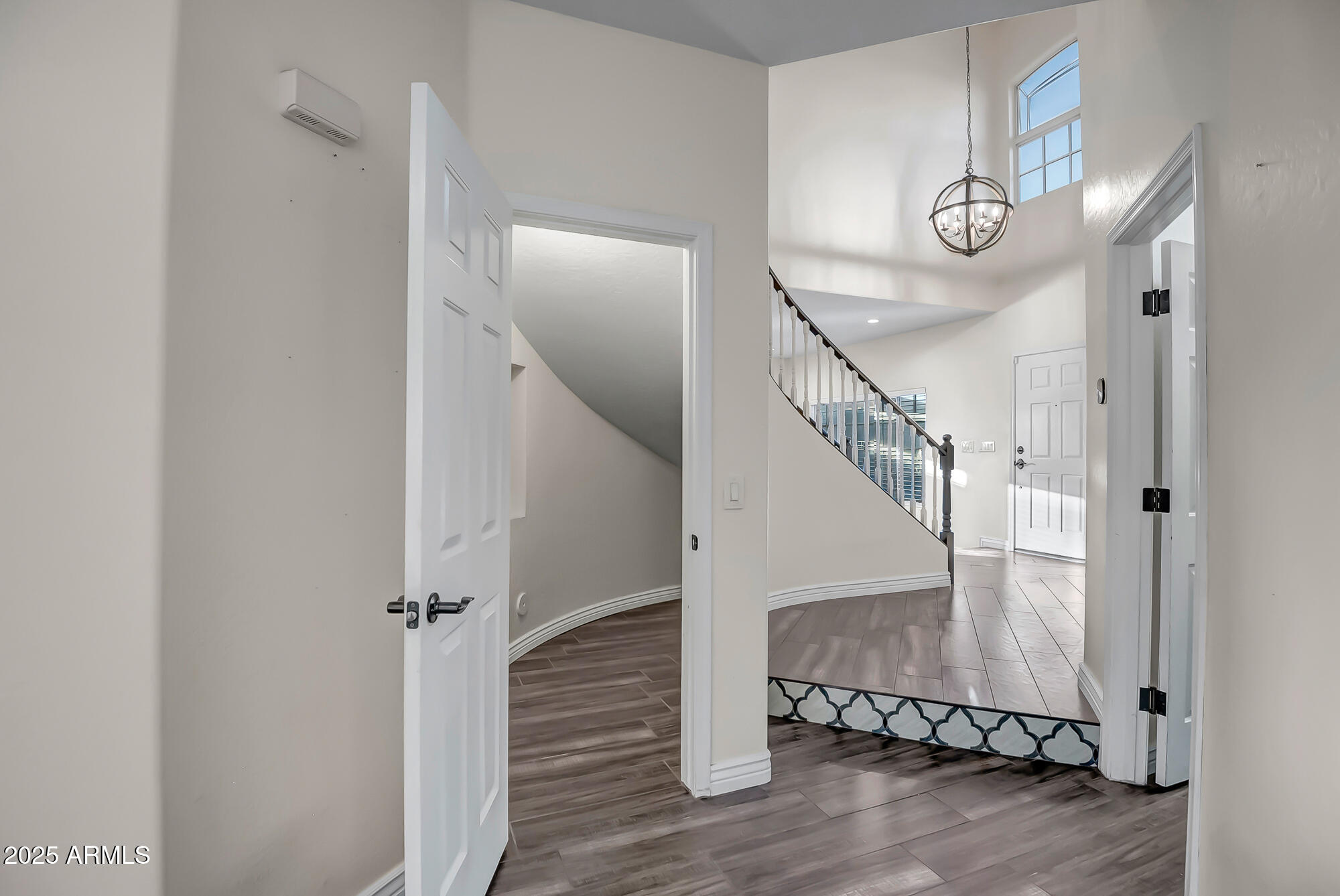 9569 West Redbird Road Peoria, AZ 85383 - Photo 27 of 36 a view of entryway and hall with wooden floor