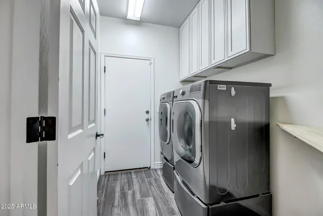 a view of a storage and utility room with a washer dryer