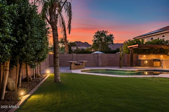 a view of a swimming pool with a yard
