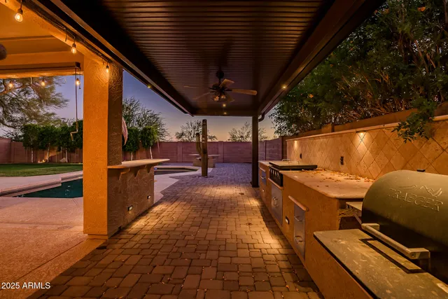 a view of a patio with table and chairs
