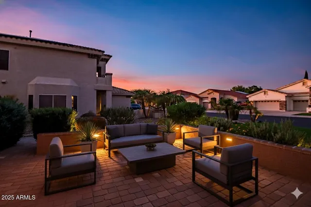 a roof deck with couches and potted plants