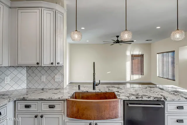 a kitchen with stainless steel appliances granite countertop a sink a stove and a microwave