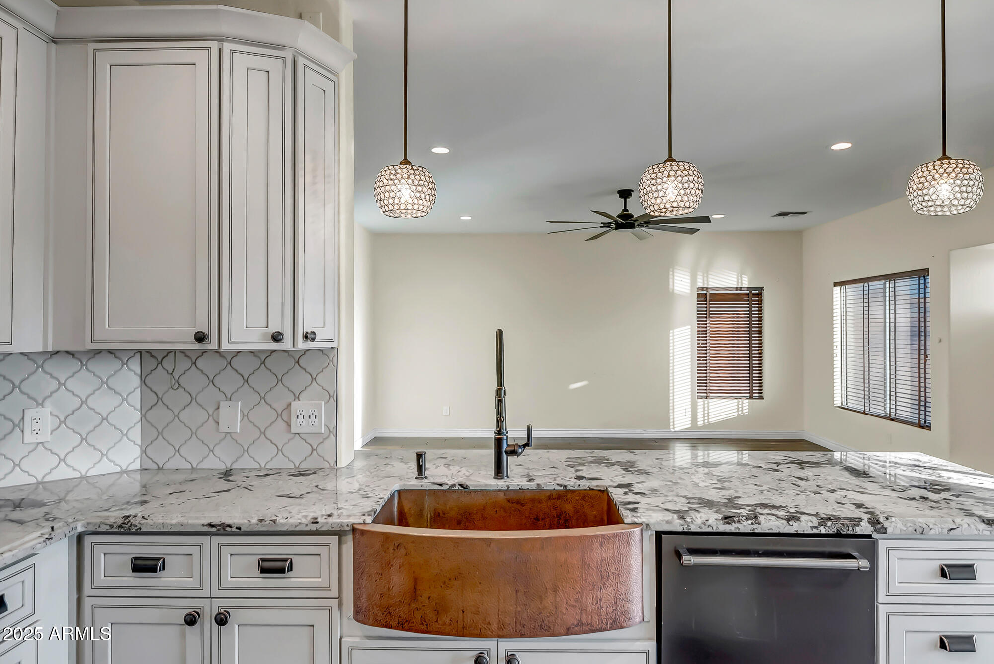 9569 West Redbird Road Peoria, AZ 85383 - Photo 4 of 36 a kitchen with stainless steel appliances granite countertop a sink a stove and a microwave