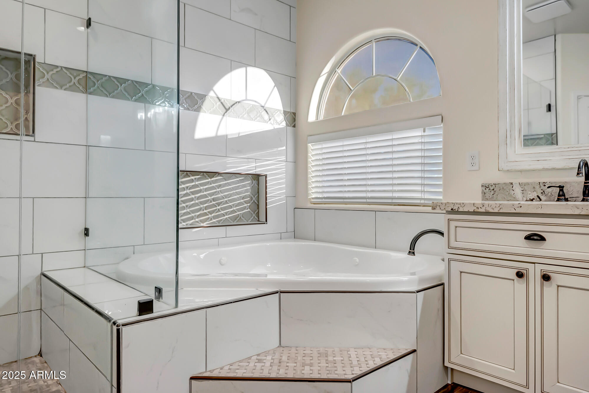 9569 West Redbird Road Peoria, AZ 85383 - Photo 5 of 36 a bathroom with a sink a vanity and a mirror