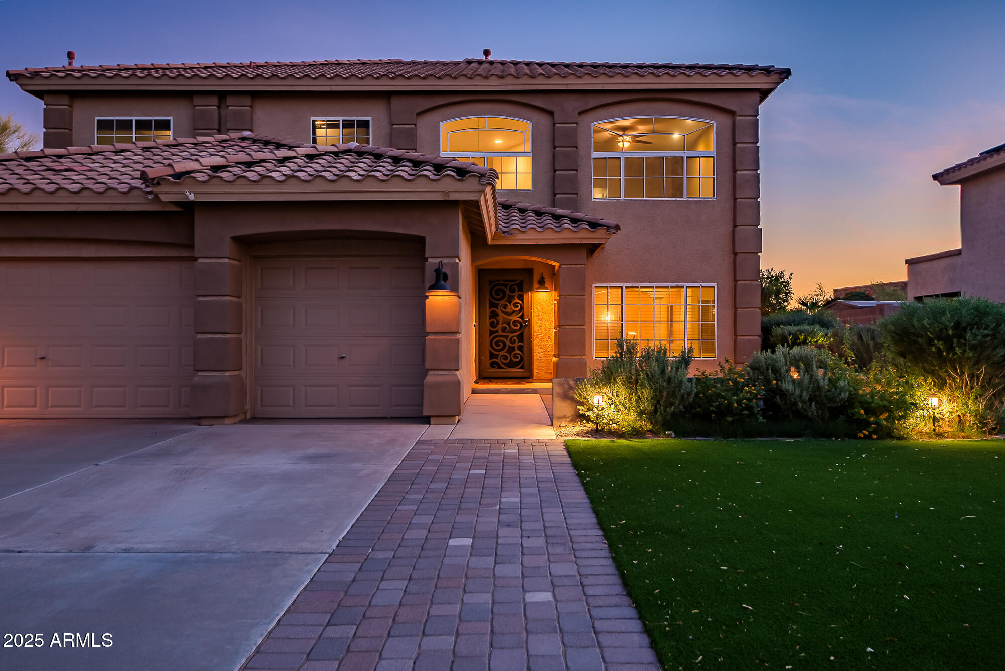 9569 West Redbird Road Peoria, AZ 85383 - Photo 6 of 36 a front view of a house with a yard