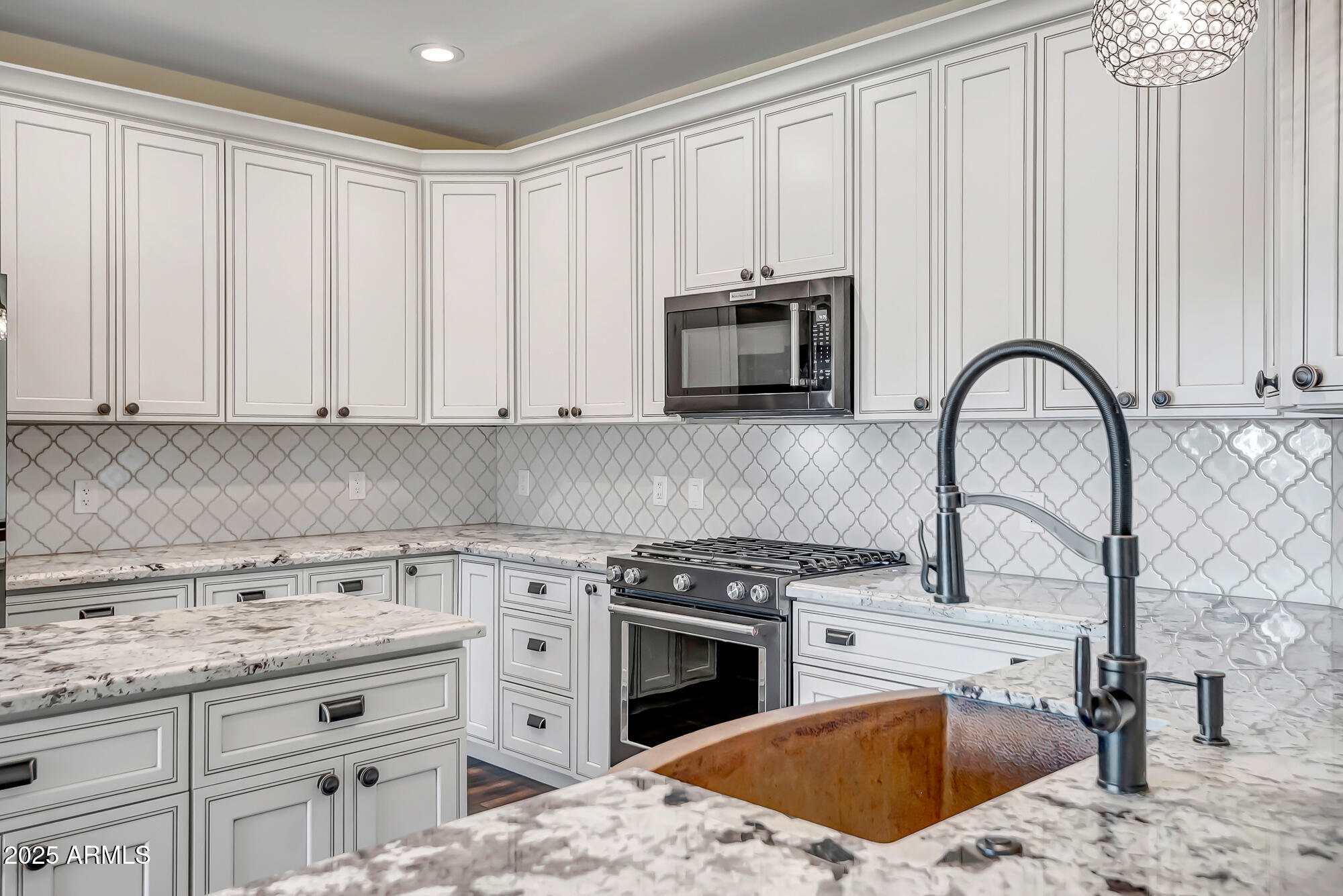 9569 West Redbird Road Peoria, AZ 85383 - Photo 9 of 36 a kitchen with appliances a sink and cabinets