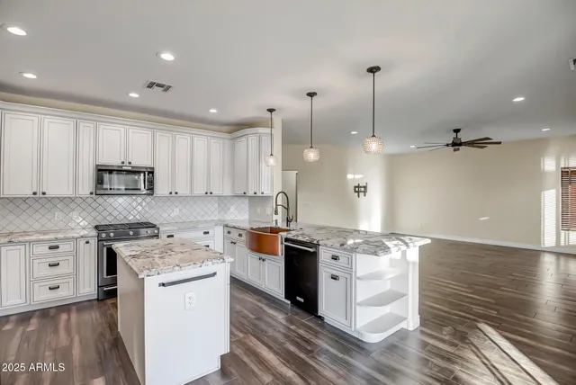 a kitchen with a stove a sink and a refrigerator