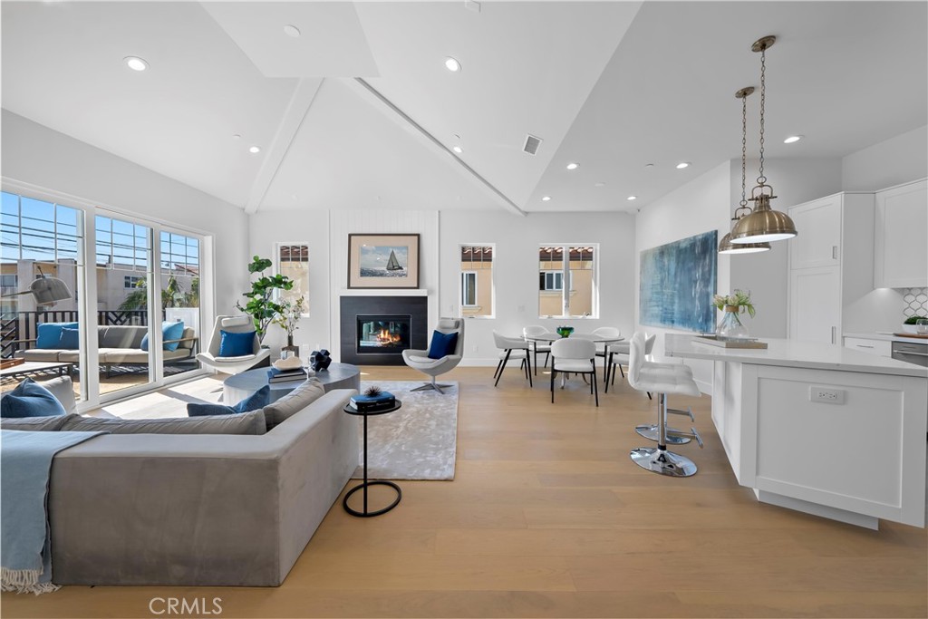 2317 Vanderbilt Lane, Unit A Redondo Beach, CA 90278 - Photo 17 of 39 a living room with furniture a fireplace and a large window