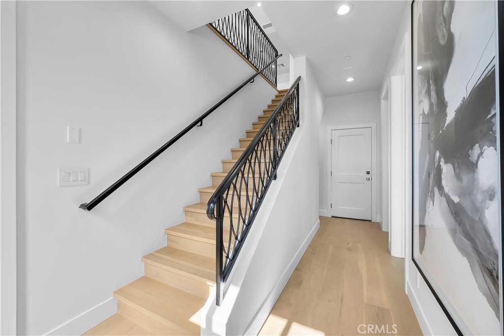 2317 Vanderbilt Lane, Unit A Redondo Beach, CA 90278 - Photo 26 of 39 a view of staircase with lots of frames on wall and wooden floor