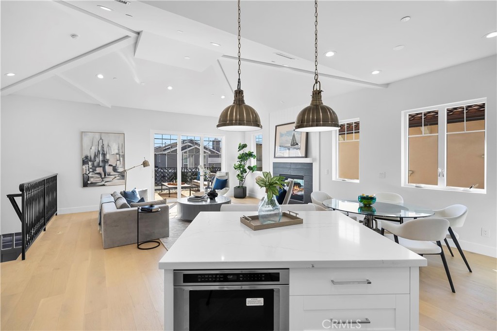 2317 Vanderbilt Lane, Unit A Redondo Beach, CA 90278 - Photo 3 of 39 a kitchen with a stove a sink a dining table and chairs
