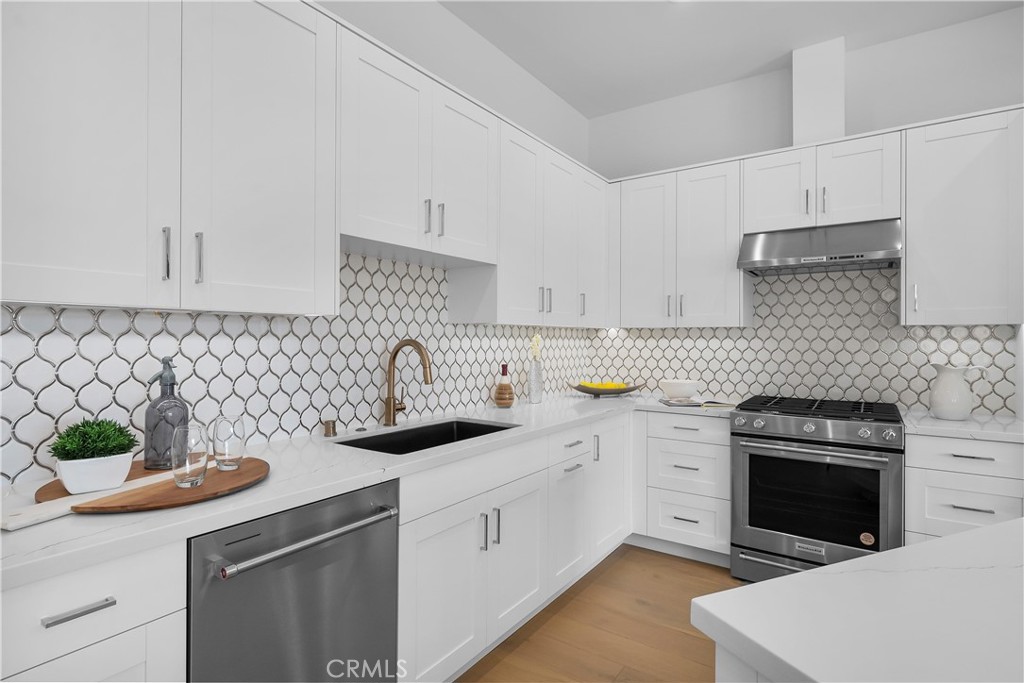 2317 Vanderbilt Lane, Unit A Redondo Beach, CA 90278 - Photo 6 of 39 a kitchen with white cabinets white appliances and sink