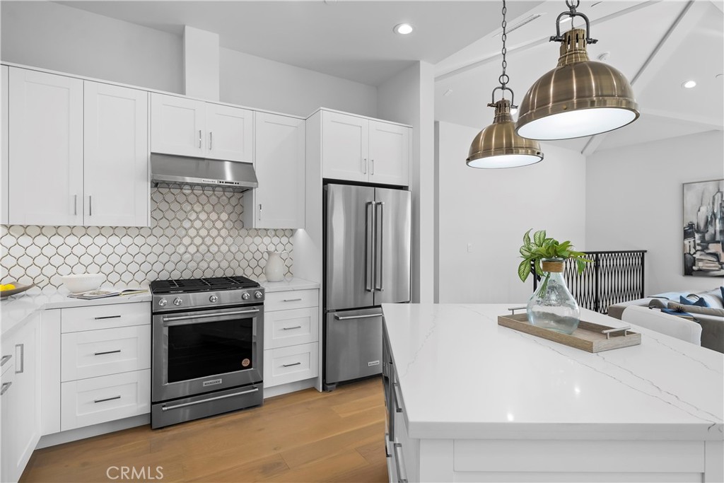 2317 Vanderbilt Lane, Unit A Redondo Beach, CA 90278 - Photo 7 of 39 a kitchen with kitchen island a stove a sink and a refrigerator
