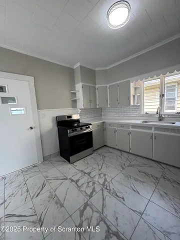 a kitchen with stainless steel appliances granite countertop a sink and cabinets