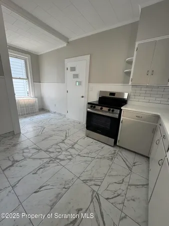 a kitchen with a stove and a refrigerator