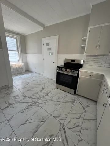 a kitchen with a stove and a refrigerator