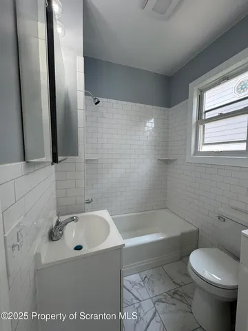 a bathroom with a sink a toilet and a bathtub