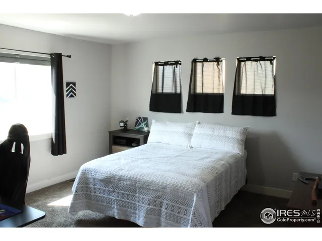 a bedroom with a bed and with mirror