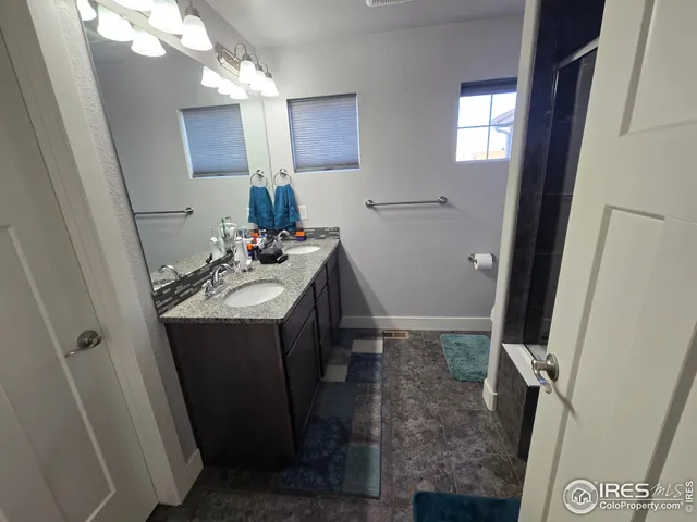a bathroom with a sink vanity and mirror