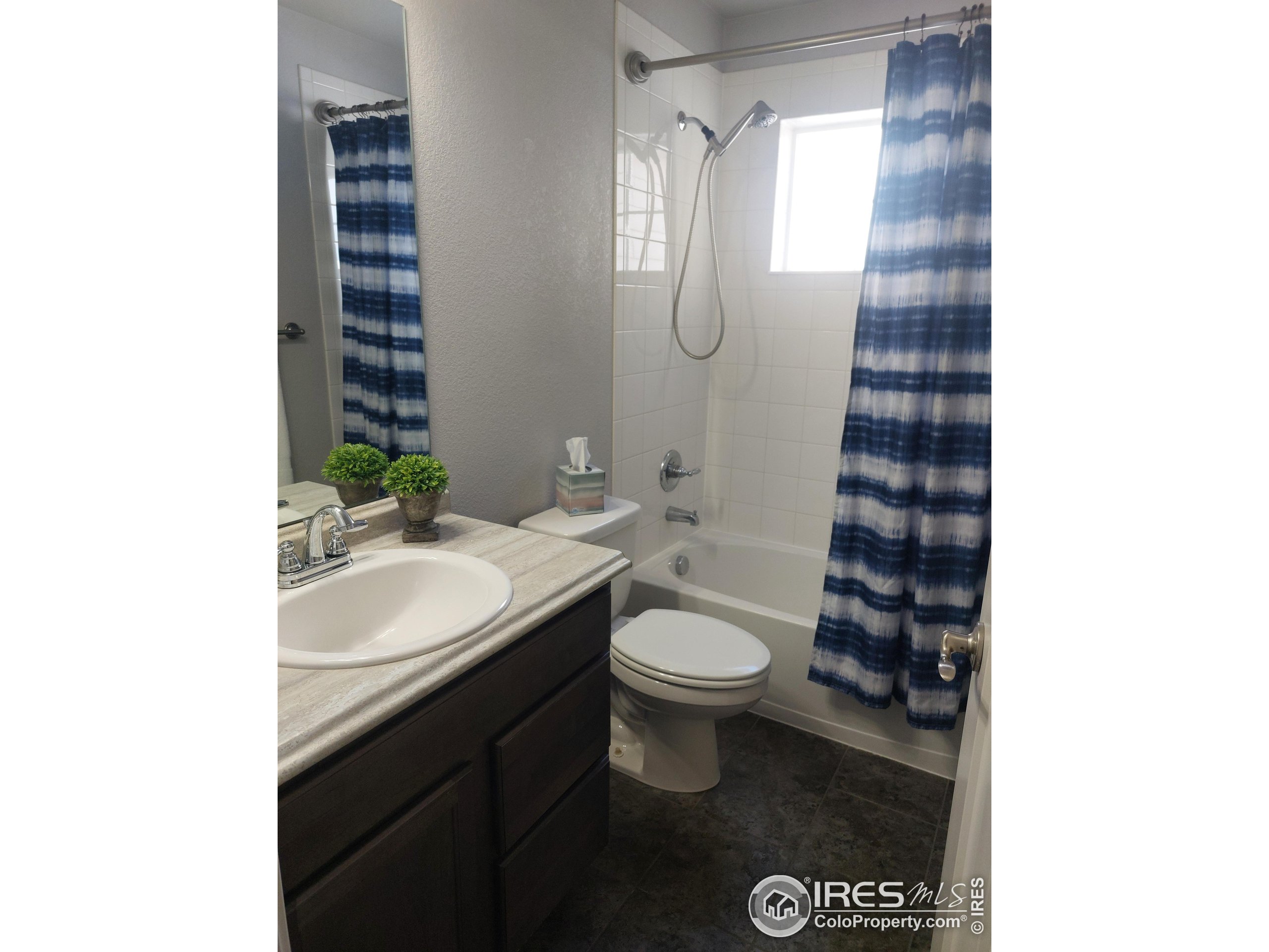 2263 Adobe Drive Fort Collins, CO 80525 - Photo 23 of 25 a bathroom with a sink and a mirror