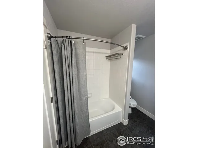 a bathroom with a shower and a toilet