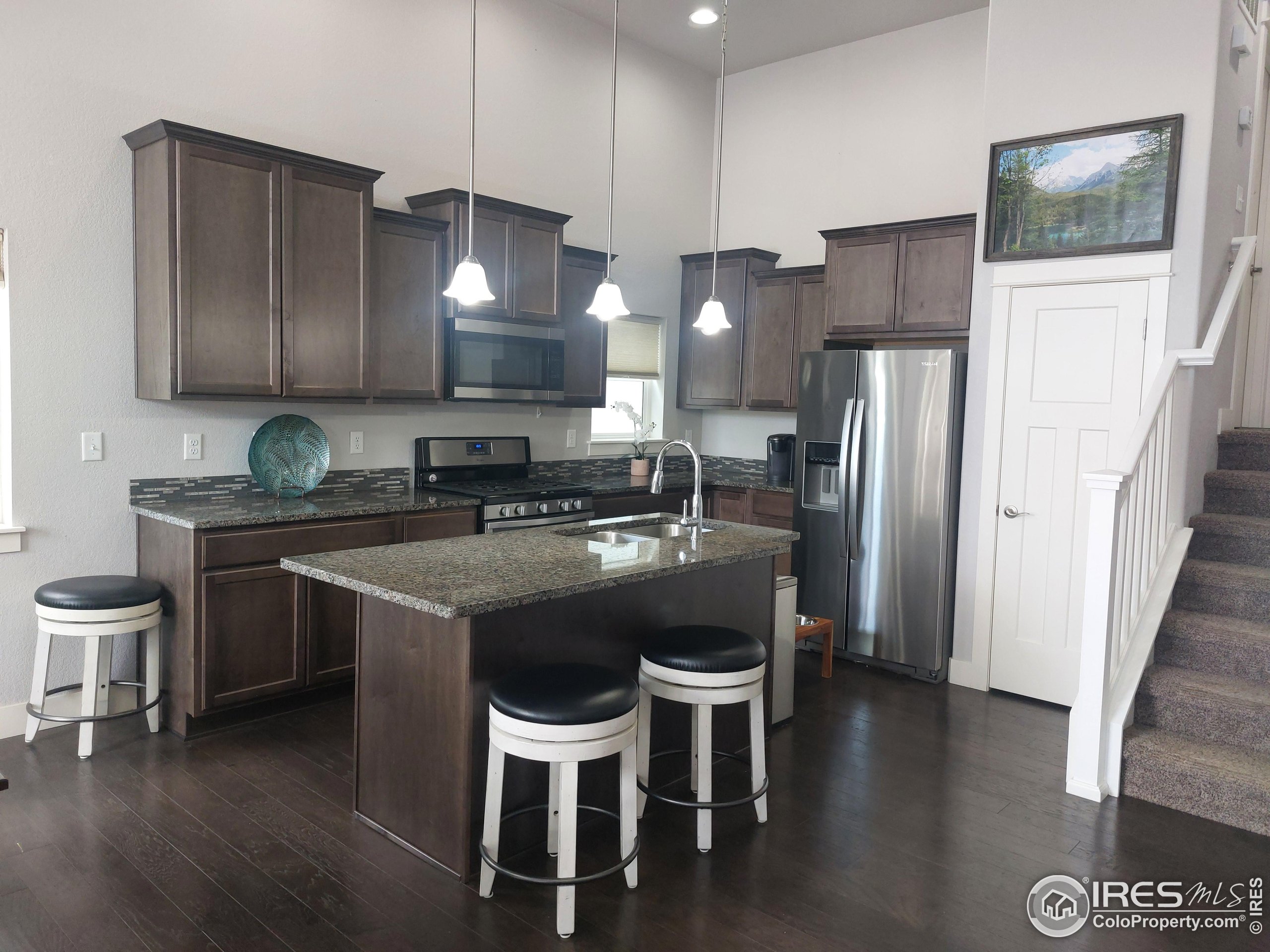 2263 Adobe Drive Fort Collins, CO 80525 - Photo 7 of 25 a kitchen with a sink cabinets and refrigerator