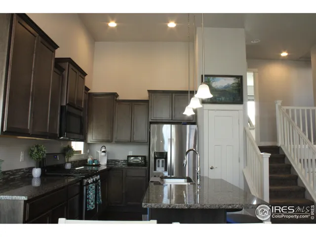 a kitchen with refrigerator and cabinets