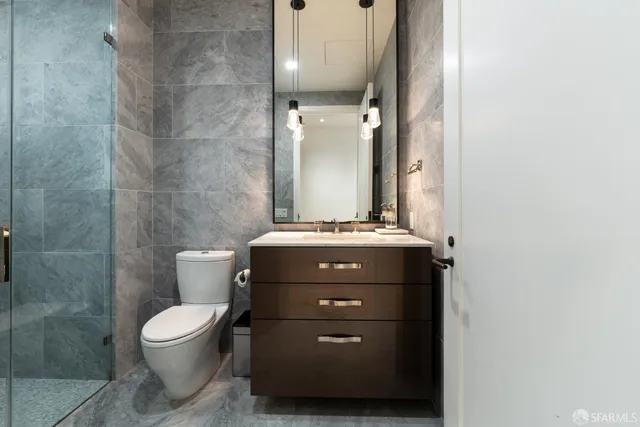 a bathroom with a toilet a sink and mirror