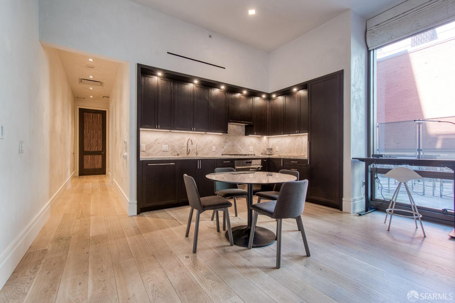 288 Pacific Avenue, Unit 2F San Francisco, CA 94111 - Photo 18 of 34 a kitchen with a table and chairs in it