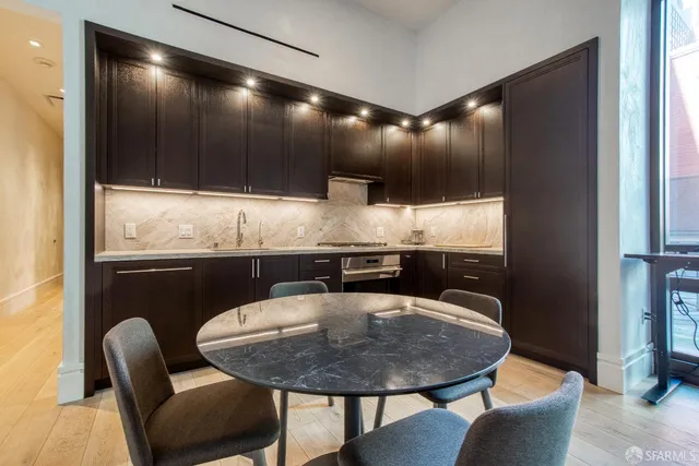 a dining room with furniture and wooden floor