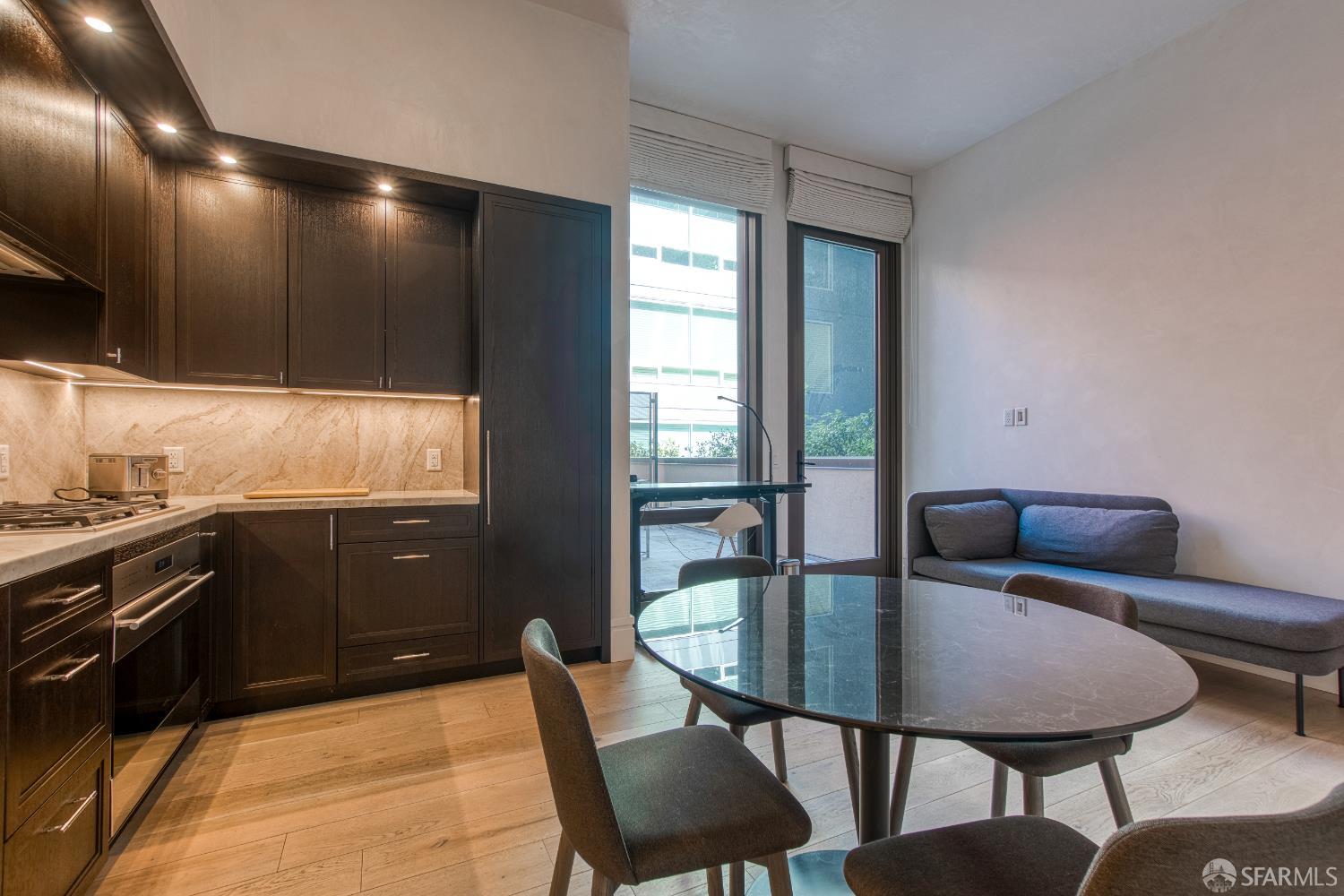 288 Pacific Avenue, Unit 2F San Francisco, CA 94111 - Photo 22 of 34 a kitchen with a table chairs sink and cabinets