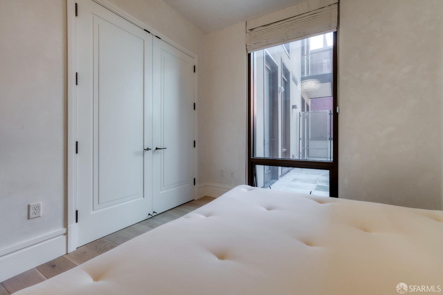 288 Pacific Avenue, Unit 2F San Francisco, CA 94111 - Photo 28 of 34 a bedroom with a bed and a mirror