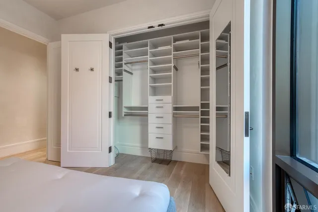 a view of walk in closet with empty racks