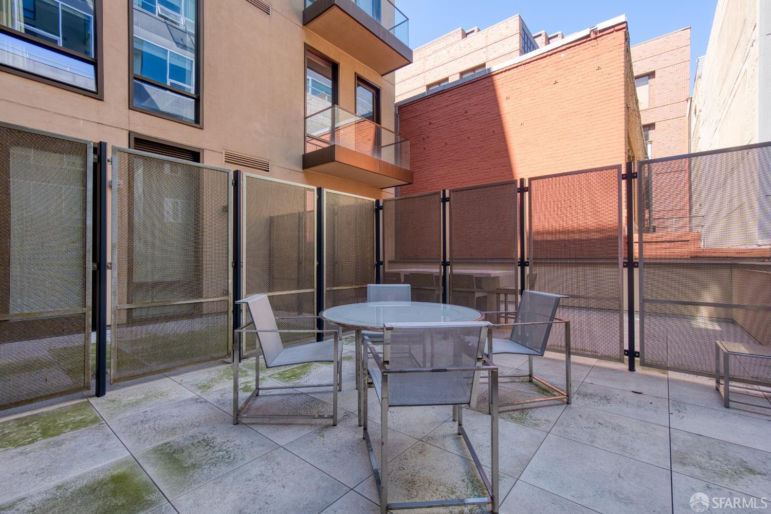 288 Pacific Avenue, Unit 2F San Francisco, CA 94111 - Photo 30 of 34 a view of backyard with a table and chairs and floor to ceiling window