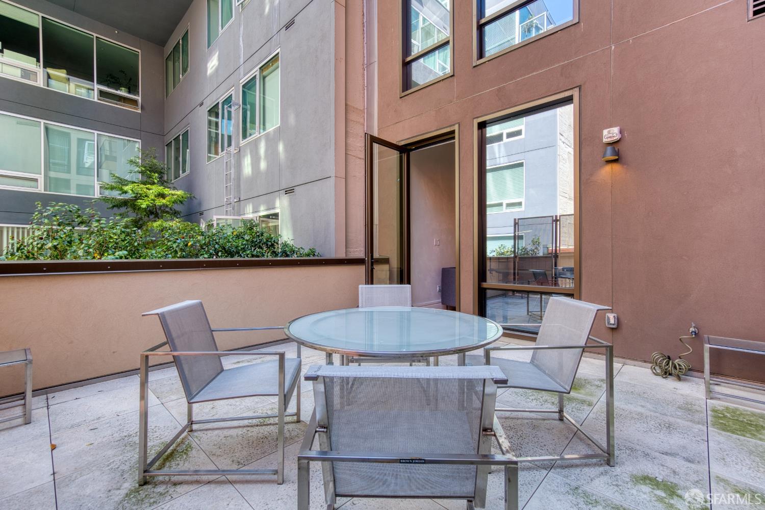 288 Pacific Avenue, Unit 2F San Francisco, CA 94111 - Photo 32 of 34 a patio with a table and chairs