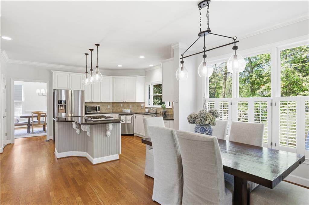 4662 Gilhams Road Roswell, GA 30075 - Photo 13 of 71 a kitchen with stainless steel appliances granite countertop a refrigerator a oven a sink with island and chairs