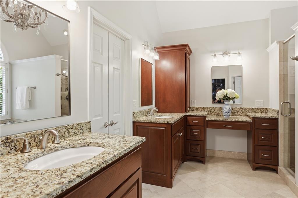 4662 Gilhams Road Roswell, GA 30075 - Photo 30 of 71 a bathroom with a granite countertop sink and a mirror
