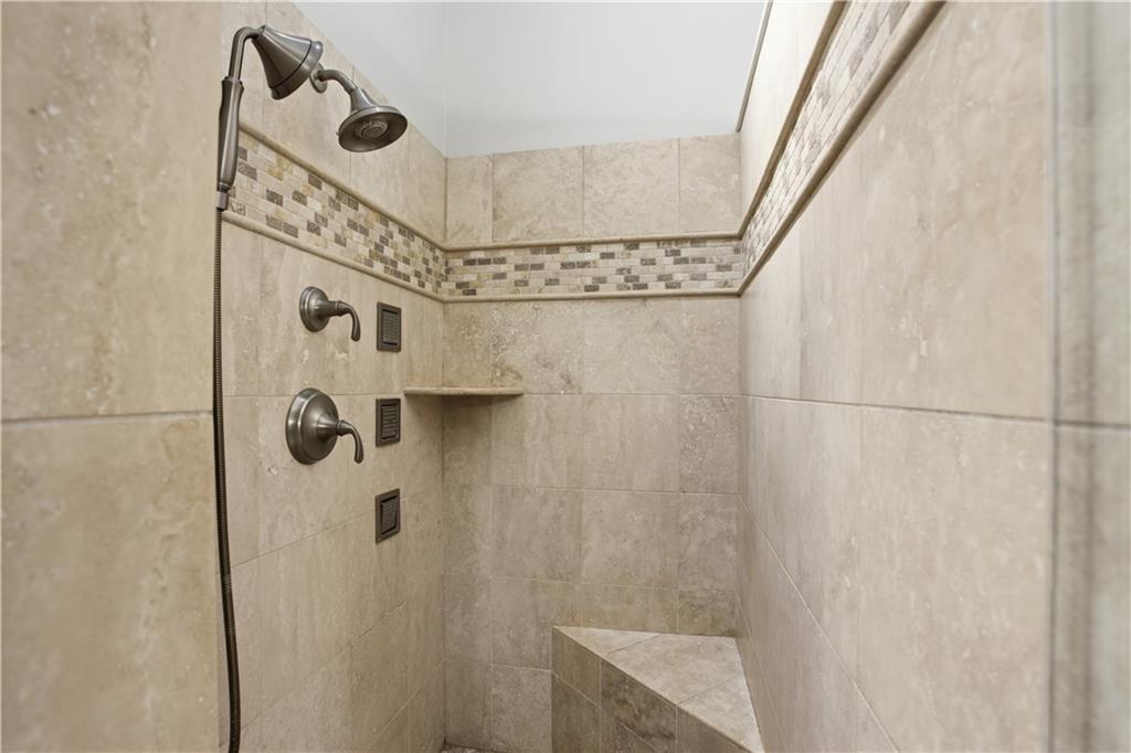 4662 Gilhams Road Roswell, GA 30075 - Photo 31 of 71 a bathroom with a shower and a tub