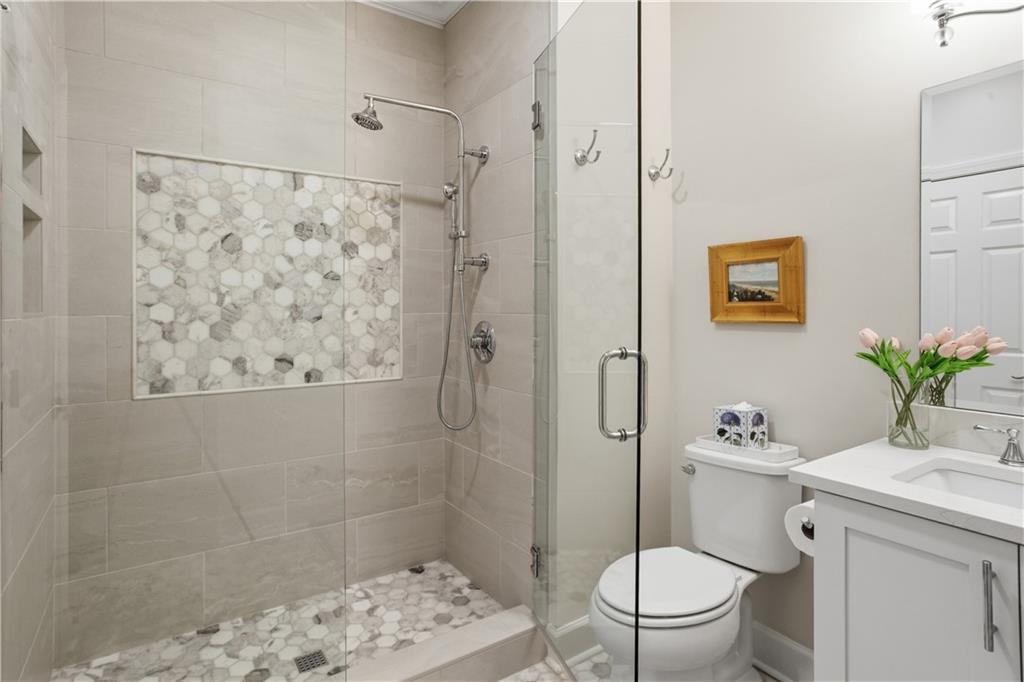 4662 Gilhams Road Roswell, GA 30075 - Photo 37 of 71 a bathroom with a sink a toilet and shower