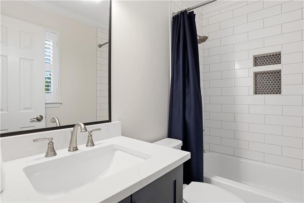 4662 Gilhams Road Roswell, GA 30075 - Photo 42 of 71 a bathroom with a sink a toilet and shower