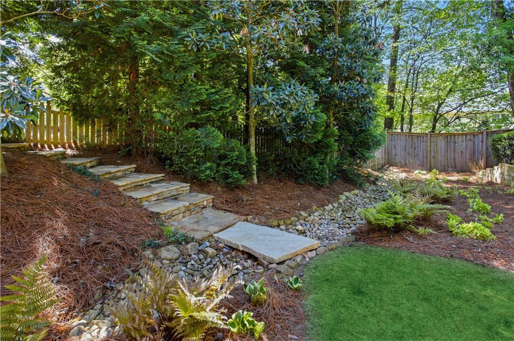 4662 Gilhams Road Roswell, GA 30075 - Photo 60 of 71 a view of a backyard with wooden fence and a bench