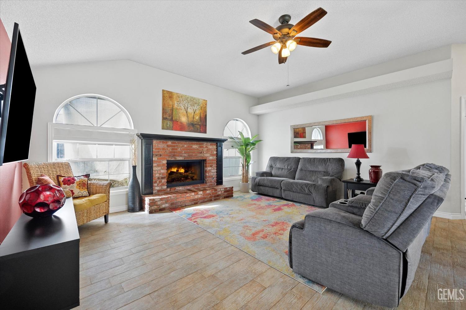 Undisclosed Address Bakersfield, CA 93308 - Photo 13 of 48 a living room with furniture a fireplace and a flat screen tv