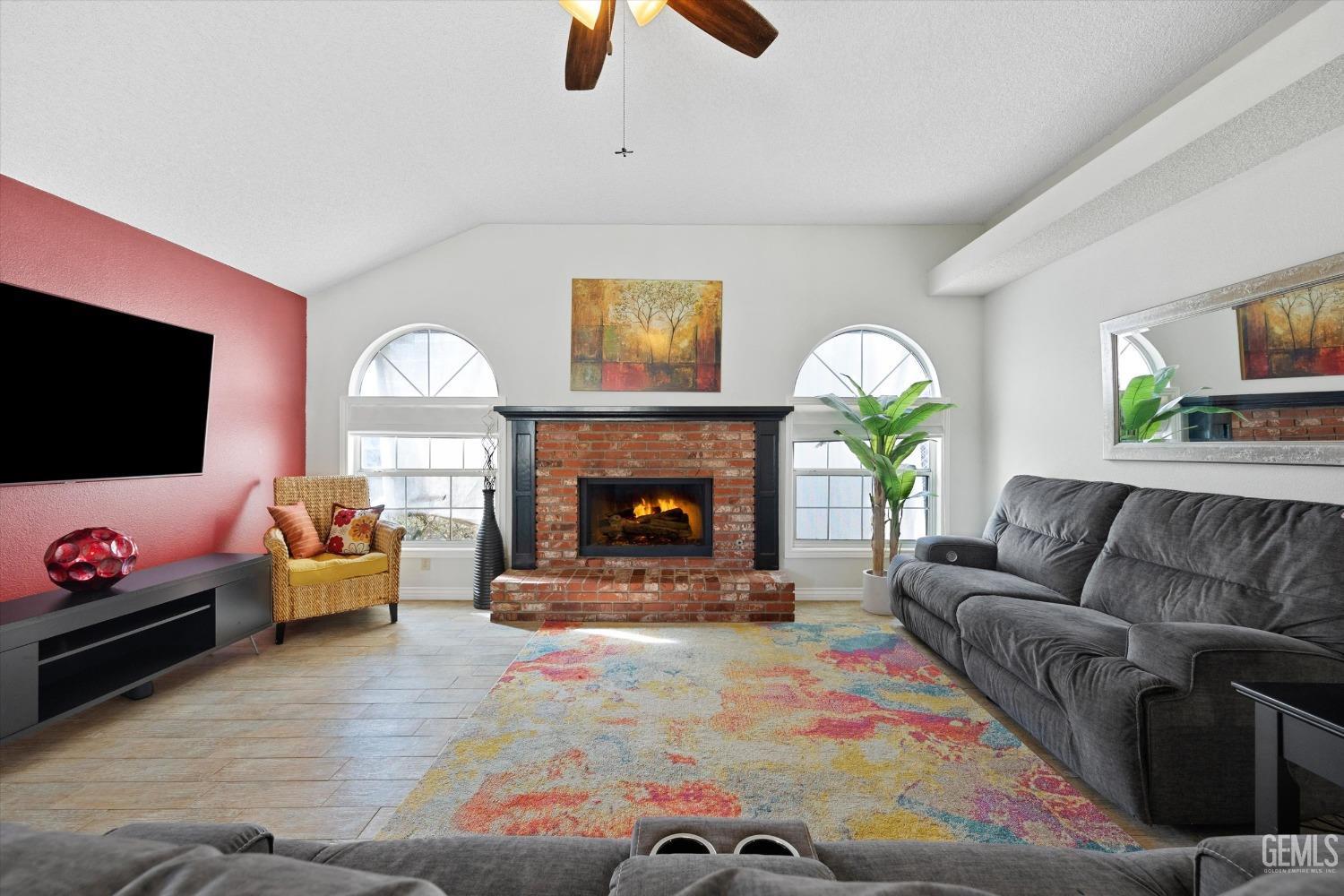 Undisclosed Address Bakersfield, CA 93308 - Photo 14 of 48 a living room with furniture a flat screen tv and a fireplace