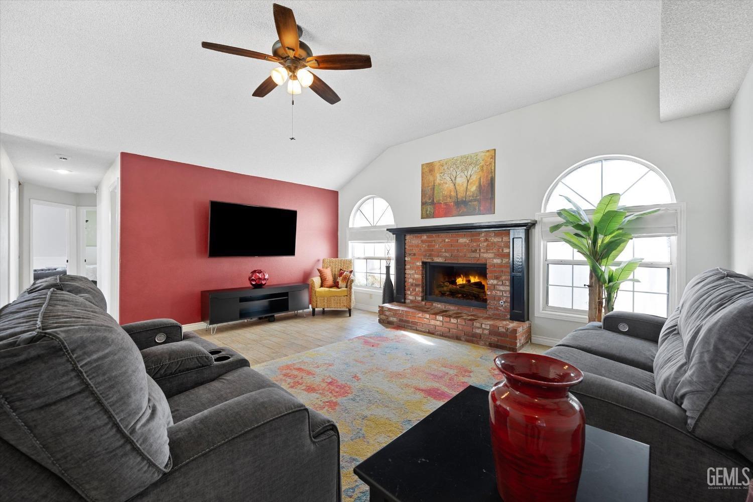 Undisclosed Address Bakersfield, CA 93308 - Photo 15 of 48 a living room with furniture a fireplace and a flat screen tv