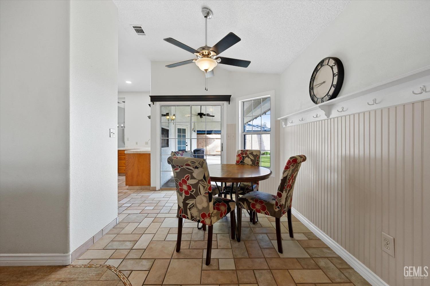 Undisclosed Address Bakersfield, CA 93308 - Photo 17 of 48 a view of a dining room and livingroom with furniture wooden floor a rug and a chandelier