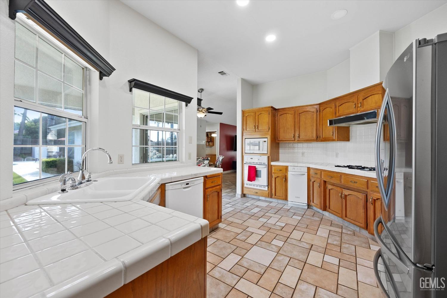 Undisclosed Address Bakersfield, CA 93308 - Photo 20 of 48 a kitchen with stainless steel appliances granite countertop a sink stove and refrigerator