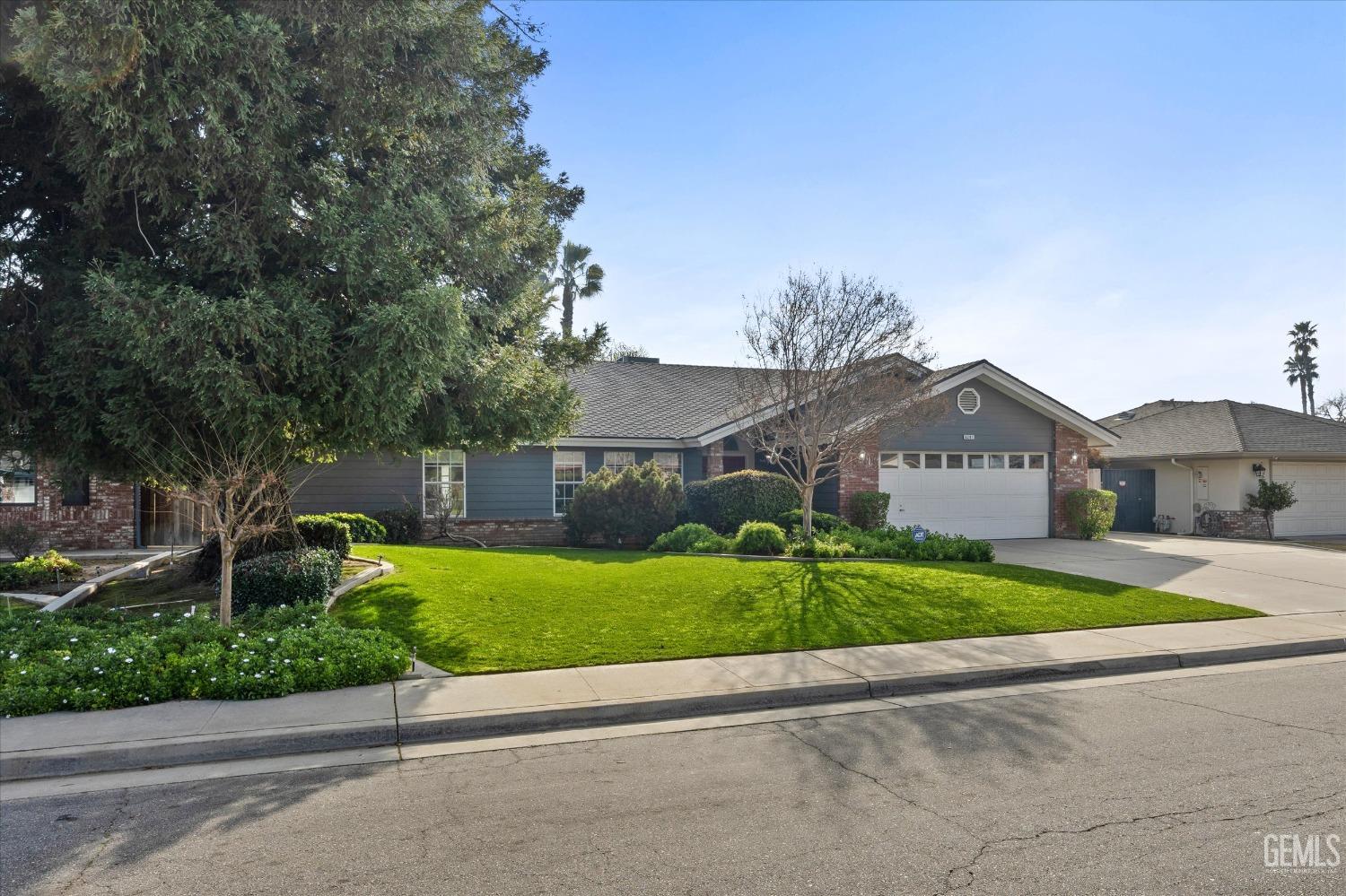 Undisclosed Address Bakersfield, CA 93308 - Photo 2 of 48 a front view of house with yard and green space