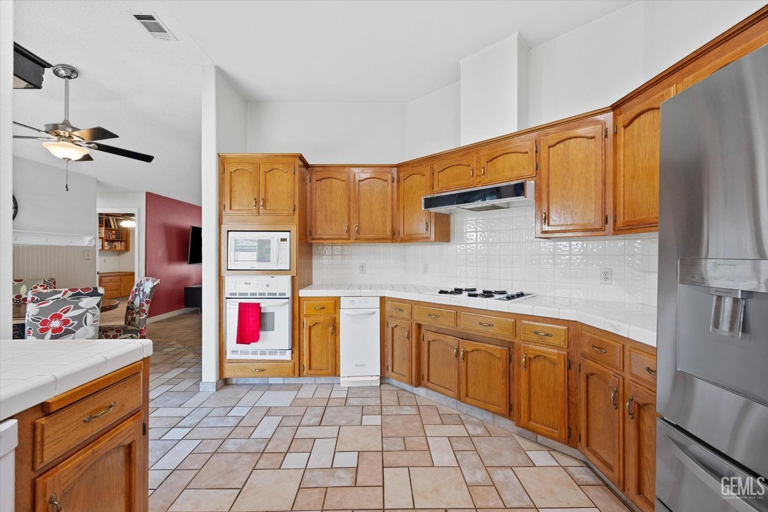 Undisclosed Address Bakersfield, CA 93308 - Photo 21 of 48 a kitchen with stainless steel appliances granite countertop a sink and cabinets