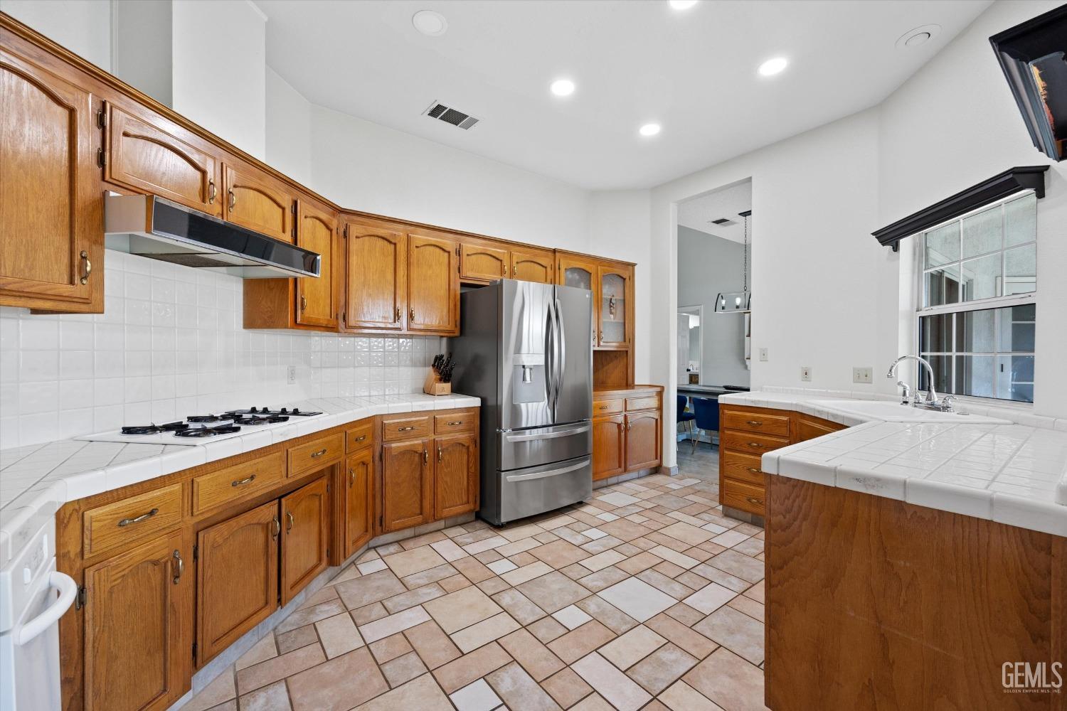 Undisclosed Address Bakersfield, CA 93308 - Photo 22 of 48 a kitchen with stainless steel appliances granite countertop a sink stove and refrigerator